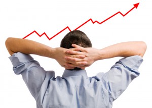 Young businessman looking at his growing share. Healthy and succ