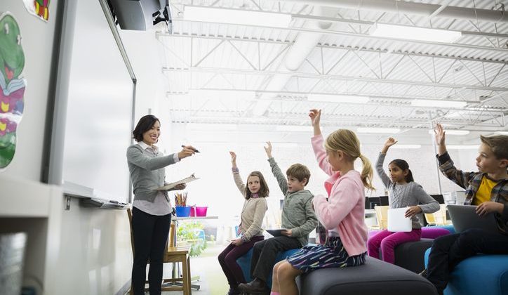 Elementary school teacher engaging with her class of students.