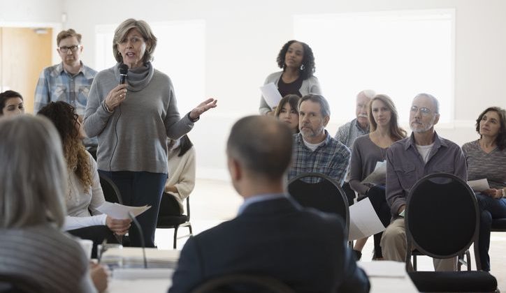 Woman Speaking at a Local Government Town Hall Meeting