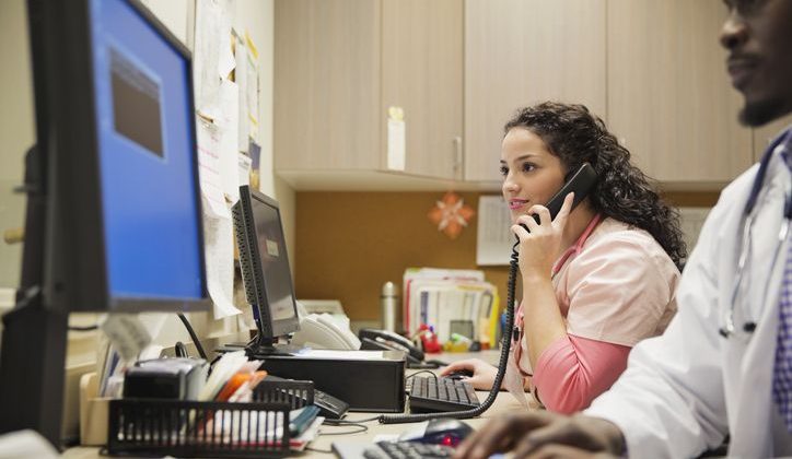 Female medical professional on the phone speaking to a patient.