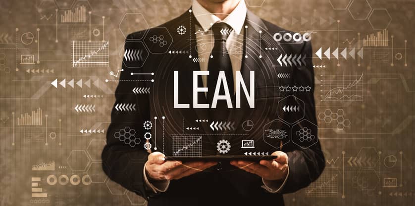 Businessman holding a laptop with Lean concepts in background
