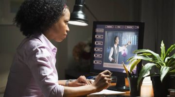 Mixed-race businesswoman taking an online class on a laptop